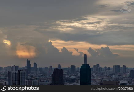 Bangkok, Thailand - Mey18, 2021 : Gorgeous panorama scenic of the sunrise or sunset with cloud on the orange and blue sky over large metropolitan city in Bangkok. Copy space, No focus, specifically.