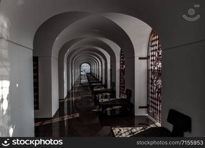 Bangkok, Thailand - Nov 23, 2019 : Beautiful of perspective shot of corridor within Loha Prasart Metal Palace at Ratchanaddaram temple, Light beams penetrate through the holes in the iron gate.