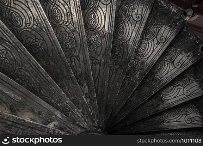 Bangkok, Thailand - Oct 05, 2019 : Upside view of a spiral staircase pattern. Spiral stairs circle in old cozy courtyard architecture. House ladder decoration interior. Architectural element of a historic building. Close-up