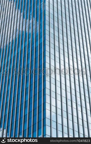 BANGKOK, THAILAND - October 3, 2019: Abstract modern building with clouds reflected in windows glass.