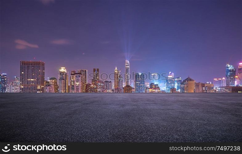 Bangkok urban cityscape skyline night scene with empty asphalt floor on front