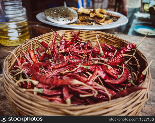 Bangladesh street food - dried red chili pepper in bamboo basket, Asian food ingredient at Dhaka market