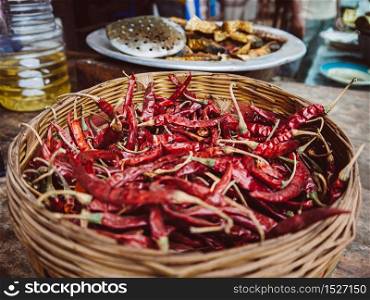 Bangladesh street food - dried red chili pepper in bamboo basket, Asian food ingredient at Dhaka market