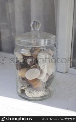 Bank of stones and shells on the windowsill