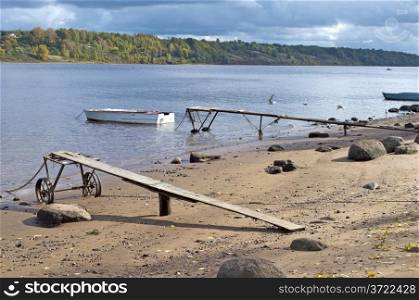 Bank of the Volga with old boats in the autumn