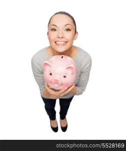 banking and investment concept - smiling woman with piggy bank