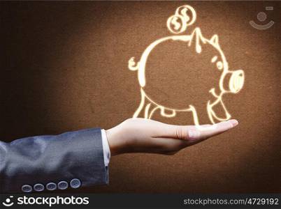 Banking concept. Close up of businessperson hand holding piggy bank
