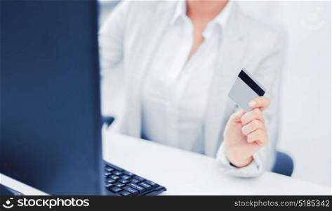 banking, shopping, money concept - businesswoman with laptop and credit card. businesswoman with laptop and credit card