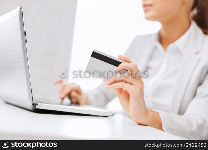 banking, shopping, money concept - businesswoman with laptop and credit card