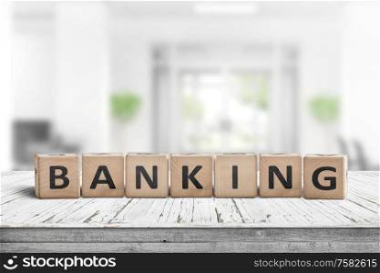 Banking sign on a wooden desk in a bright work environment
