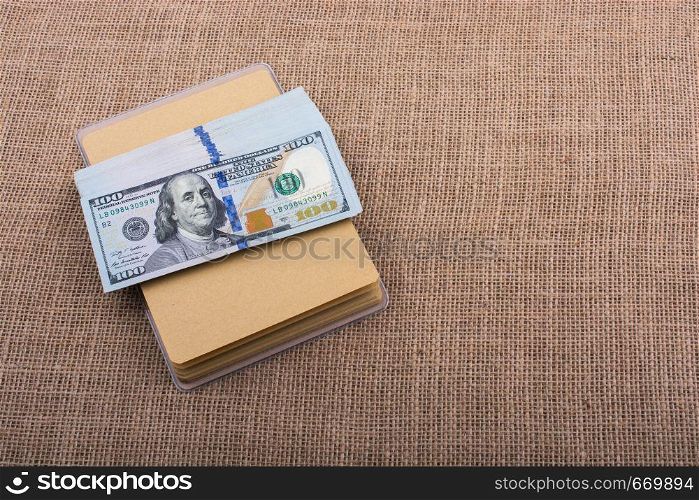 Banknote bundle of US dollar placed on a linen canvas