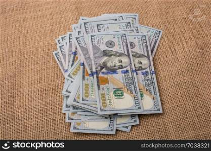 Banknote bundle of US dollar placed on a linen canvas