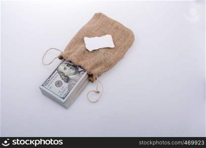 Banknote bundle of US dollarin a sack with a note paper