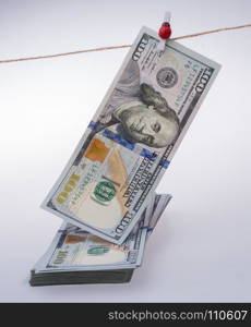 Banknote of US dollar hanging on a linen string