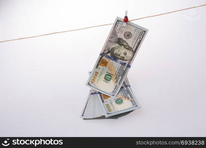 Banknote of US dollar hanging on a linen string