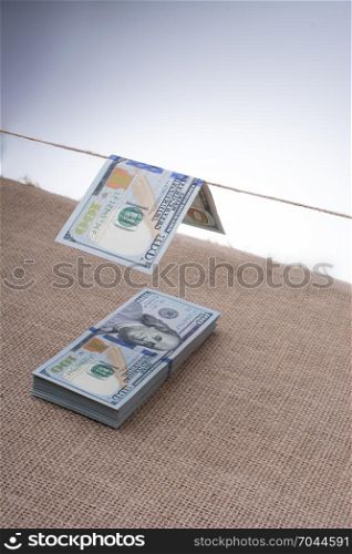 Banknote of US dollar hanging on a linen string