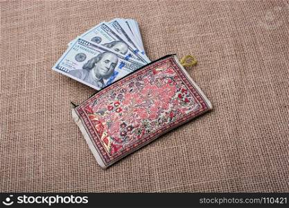 Banknote of US dollar in a purse on a linen canvas