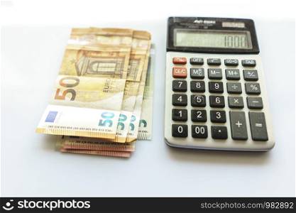Banknotes and Calculator, Euro Banknotes on White Background, Money, Finance, Tax, Profit and Costing, 50 Euro, Euro Bills, Compound Interest Rate Calculation or Financial Investment Business Concepts
