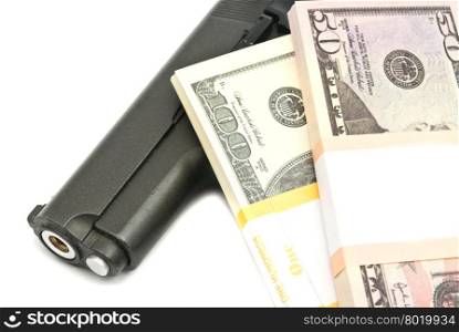 banknotes and gun on white background closeup