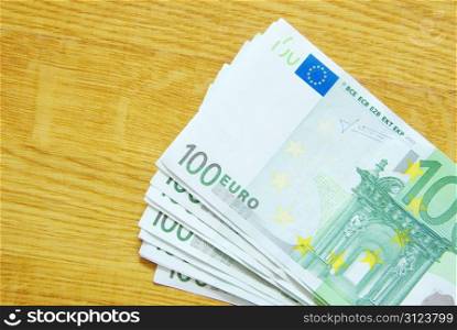 banknotes of euro isolated on a wood background