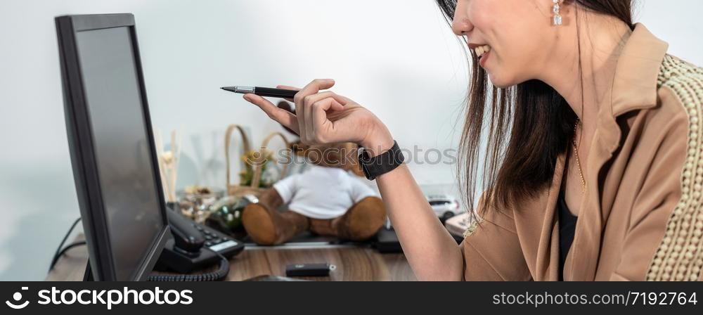 Banner and cover scene of Asian Businesswoman in formal suit using and pointing the pen to computer screen in office, business and project plan for customer service concept