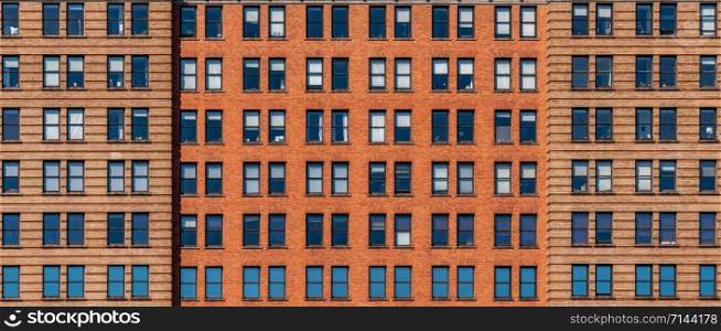 Banner and cover scene of Brown Brick high building facade with windows in New York City, United states of America, USA, Industrial Background and texture, Loft inspiration. Construction facade,