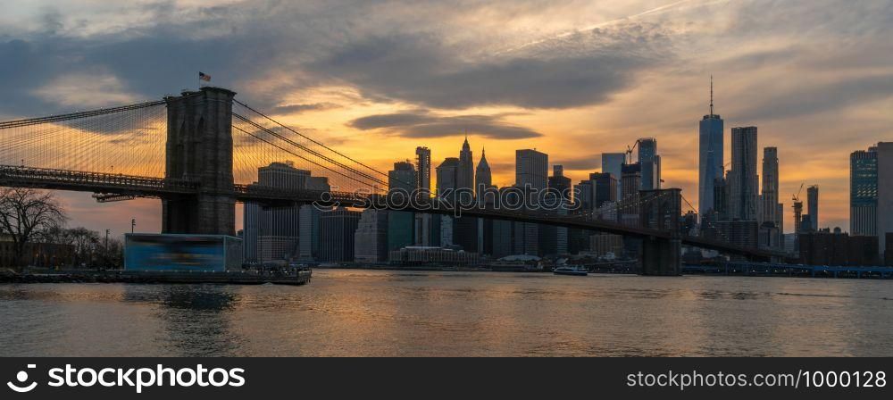 Banner and cover scene of New york Cityscape with Brooklyn Bridge over the east river at the sunset time, USA downtown skyline, Architecture and transportation concept