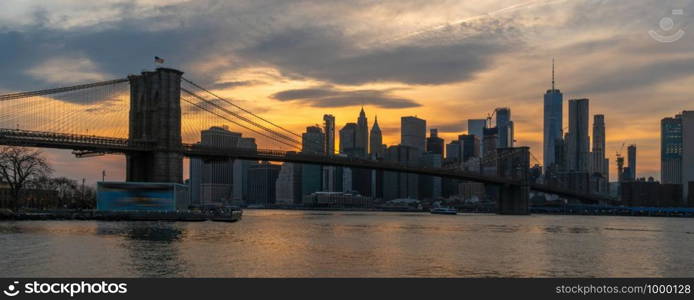 Banner and cover scene of New york Cityscape with Brooklyn Bridge over the east river at the sunset time, USA downtown skyline, Architecture and transportation concept