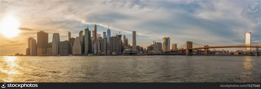 Banner and Panorama of New york Cityscape with Brooklyn Bridge over the east river at the evening time, USA downtown skyline, United states of America, Architecture and building with tourist concept