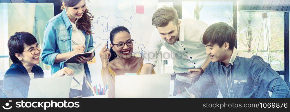 Banner and web page or cover template of Group Of Asian and Multiethnic Business people with casual suit working and brainstorming together with technology computer in the modern Office,