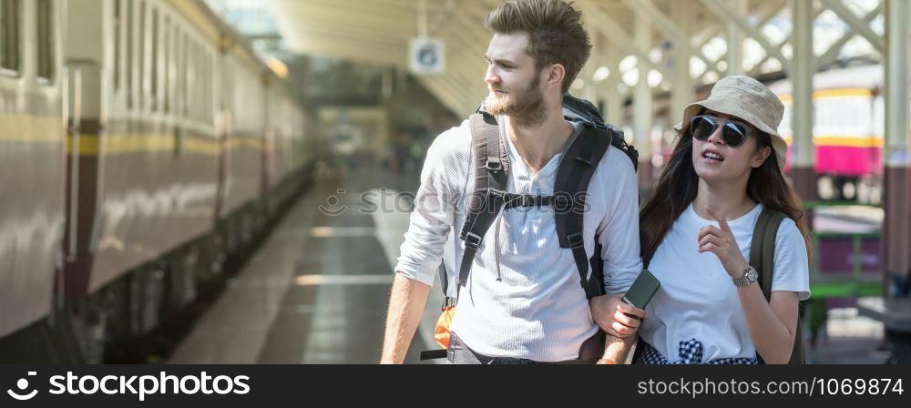 Banner and web page or cover template of Multiethnic Travelers are walking and finding the train at the train station, Travel and transportation concept