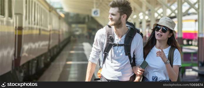 Banner and web page or cover template of Multiethnic Travelers are walking and finding the train at the train station, Travel and transportation concept