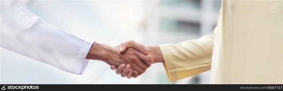 Banner Arab Businessman Muslim dress shaking hands together. Panorama Muslim Men Teamwork business partner handshake teams Partnership. multiracial UAE diversity  people trust honesty with copy space