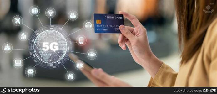 banner of Asian woman using credit card by mobile for 5G technology with various icon internet of thing in department store, technology money wallet and online payment concept, credit card mockup
