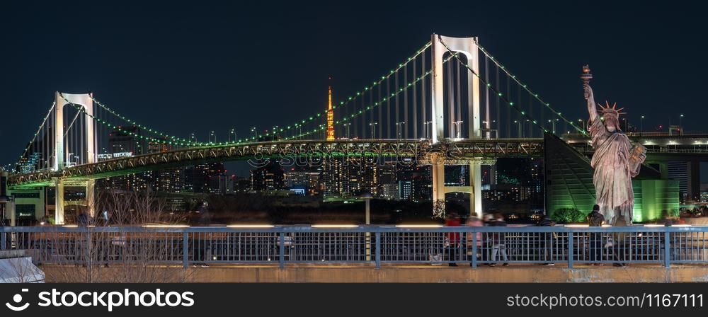 Banner of Statue of Liberty and Rainbow bridge at night time, located at Odaiba Tokyo, Japan,