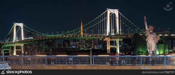 Banner of Statue of Liberty and Rainbow bridge at night time, located at Odaiba Tokyo, Japan,