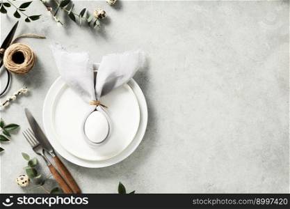 Banner. Stylish Easter flat lay, table setting with egg in easter bunny napkin. Modern natural dyed egg on napkin with bunny ears, flowers on vintage plate. Happy Easter holiday concept for cafes and restaurants copy space