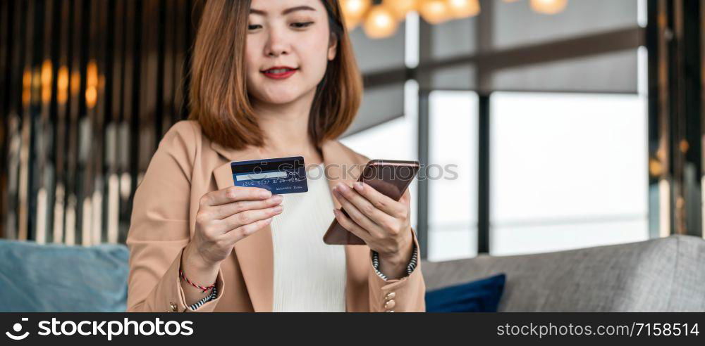 Banner, web page or cover template of Asian woman using credit card with mobile phone, laptop for online shopping in modern lobby, technology money wallet and online payment concept,credit card mockup