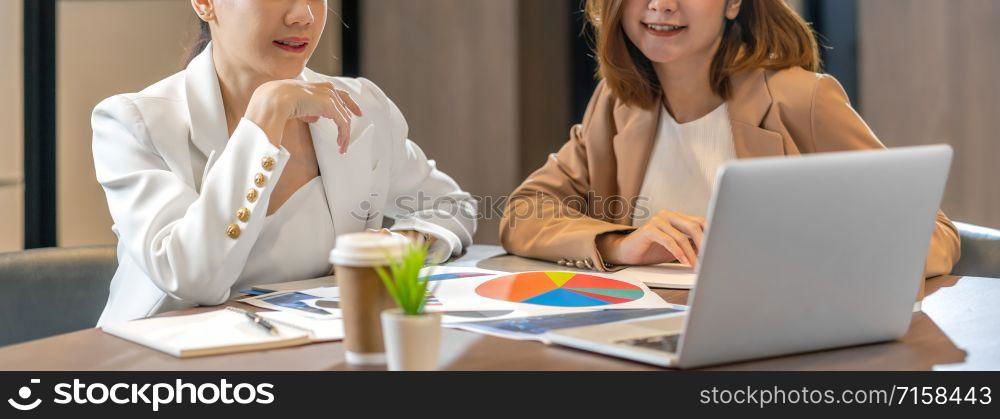 Banner, web page or cover template of Two asian businesswomen working with the partner business via technology laptop in modern meeting room, office or working space, partner and colleague concept