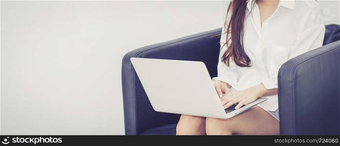 Banner website beautiful of portrait young asian woman using laptop for leisure on sofa, girl working online internet with notebook freelance, communication business concept.