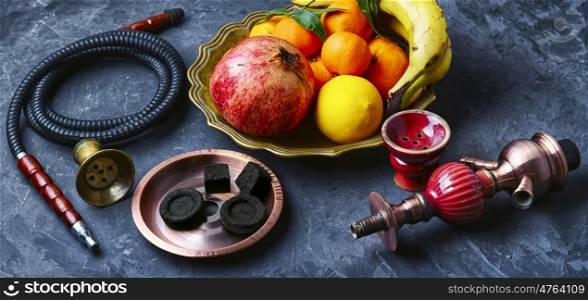 banner with smoking hookah and dish with tangerines,pomegranate and banana
