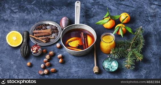 banner with wine cocktail mulled wine. Hot wine with orange and spices set on dark slate background
