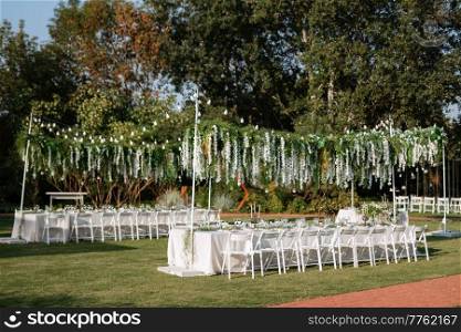 Banquet in the garden for a wedding with decorative elements, atmospheric decor