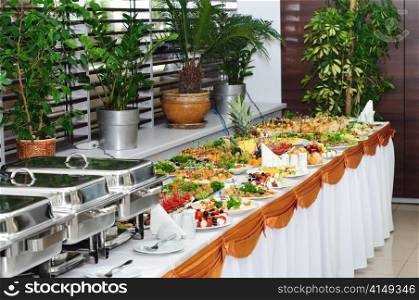 banquet table with chafing dish heaters and canapes. banquet table