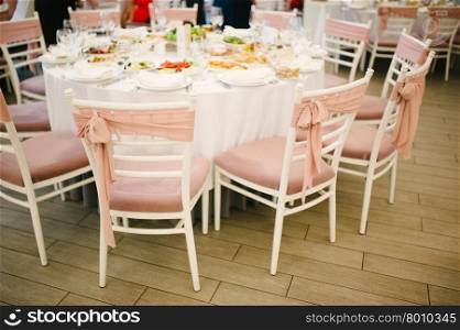 Banquet wedding chairs setting on evening reception awaiting guests. Banquet wedding chairs setting on evening reception