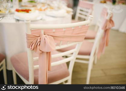 Banquet wedding chairs setting on evening reception awaiting guests. Banquet wedding chairs setting on evening reception