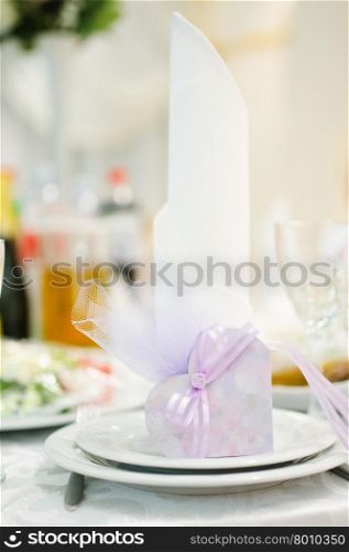 Banquet wedding invitation on table setting on evening reception awaiting guests. Banquet wedding invitation on table setting on evening reception