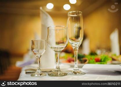 Banquet wedding table setting on evening reception awaiting guests. wineglass or glass Banquet wedding table setting