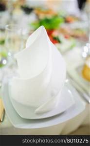 Banquet wedding table setting on evening reception awaiting guests. Banquet wedding plate on table setting on evening reception