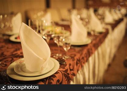 Banquet wedding table setting on evening reception awaiting guests. Banquet wedding table setting on evening reception